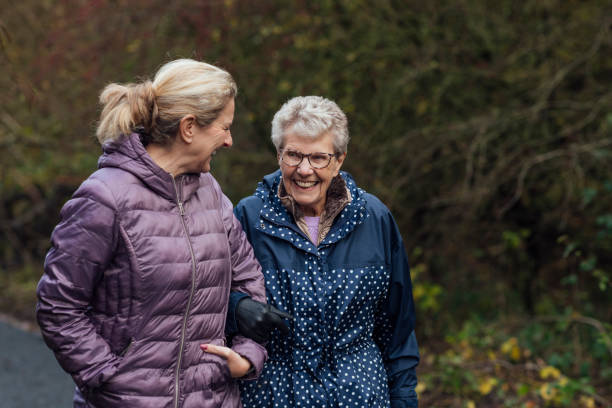 Lady walking with older person who has dementia