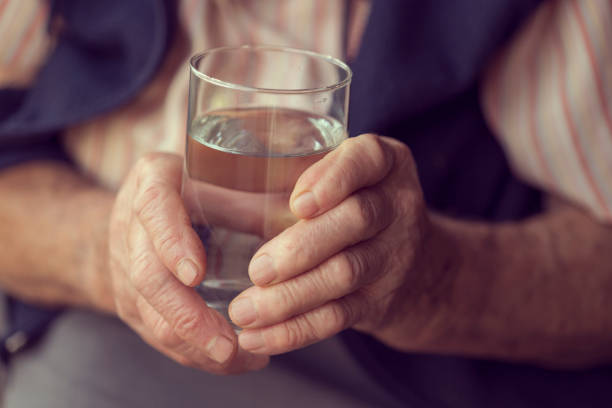 holding glass of water